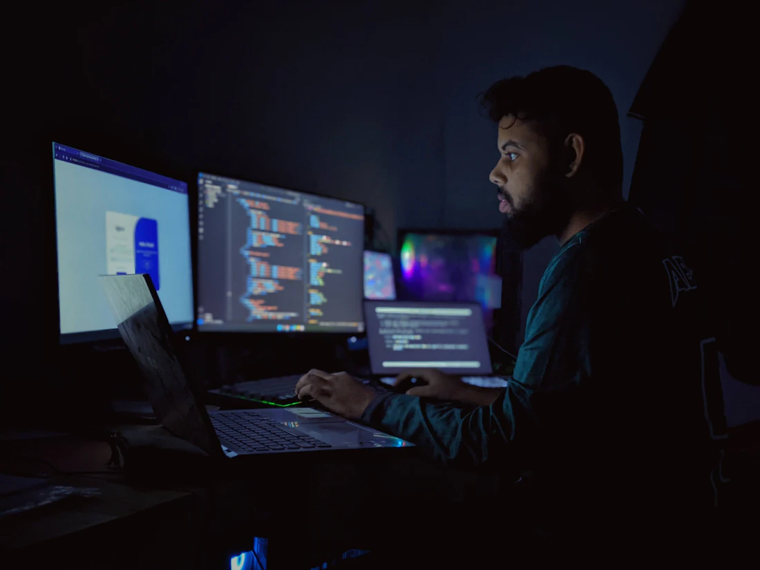 A developer rebuilding a website across several monitors
